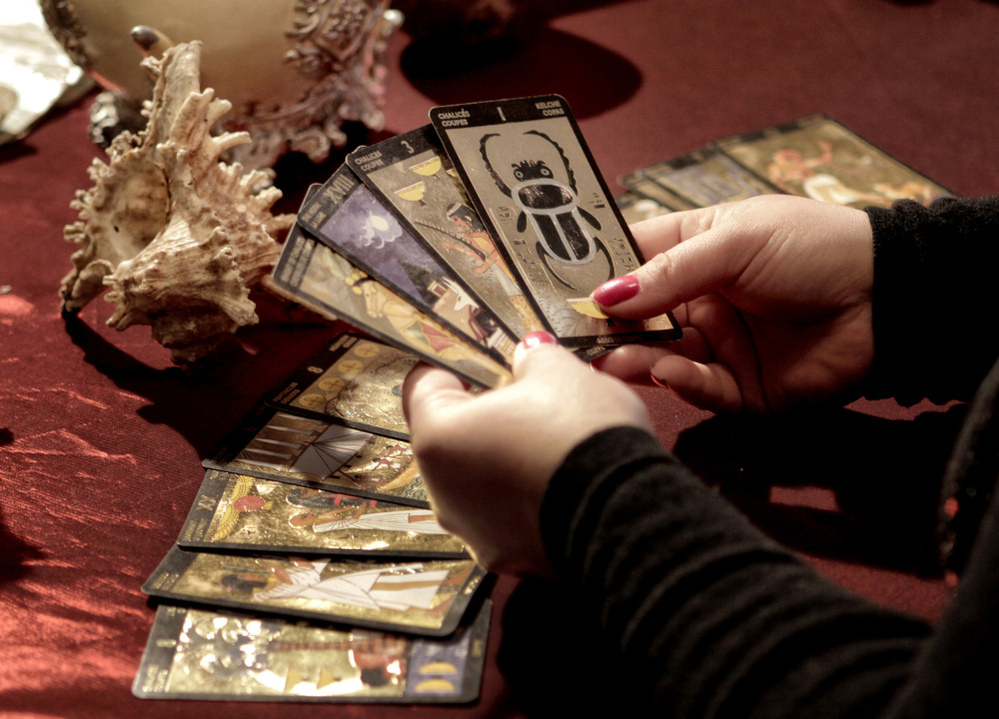 Romanian witch Mihaela Minca holds cards during an interview with The Associated Press in Mogosoaia, Romania in January.