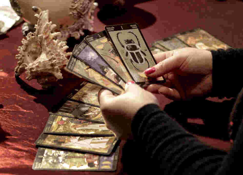 Romanian witch Mihaela Minca holds cards during an interview with The Associated Press in Mogosoaia, Romania in January.