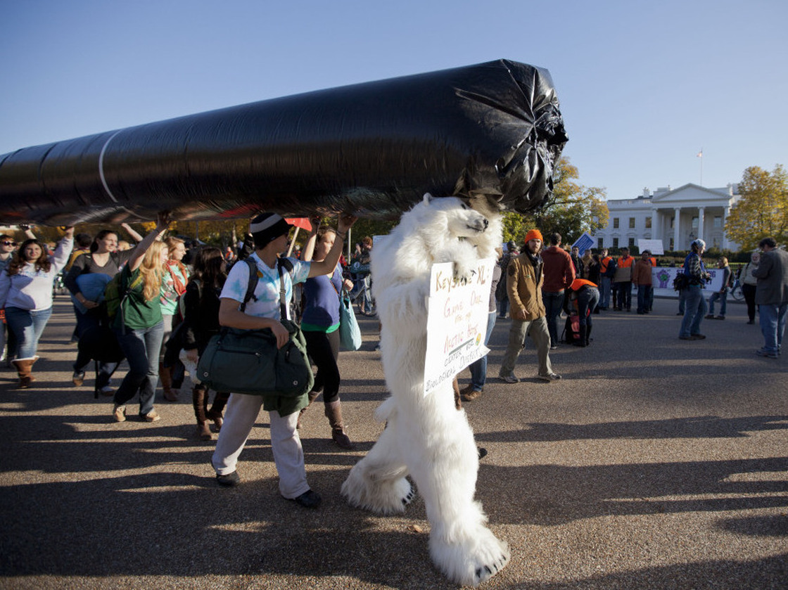 Demonstrators march with a replica of a pipeline during a protest to demand a stop to the Keystone XL tar sands oil pipeline outside the White House last November. 