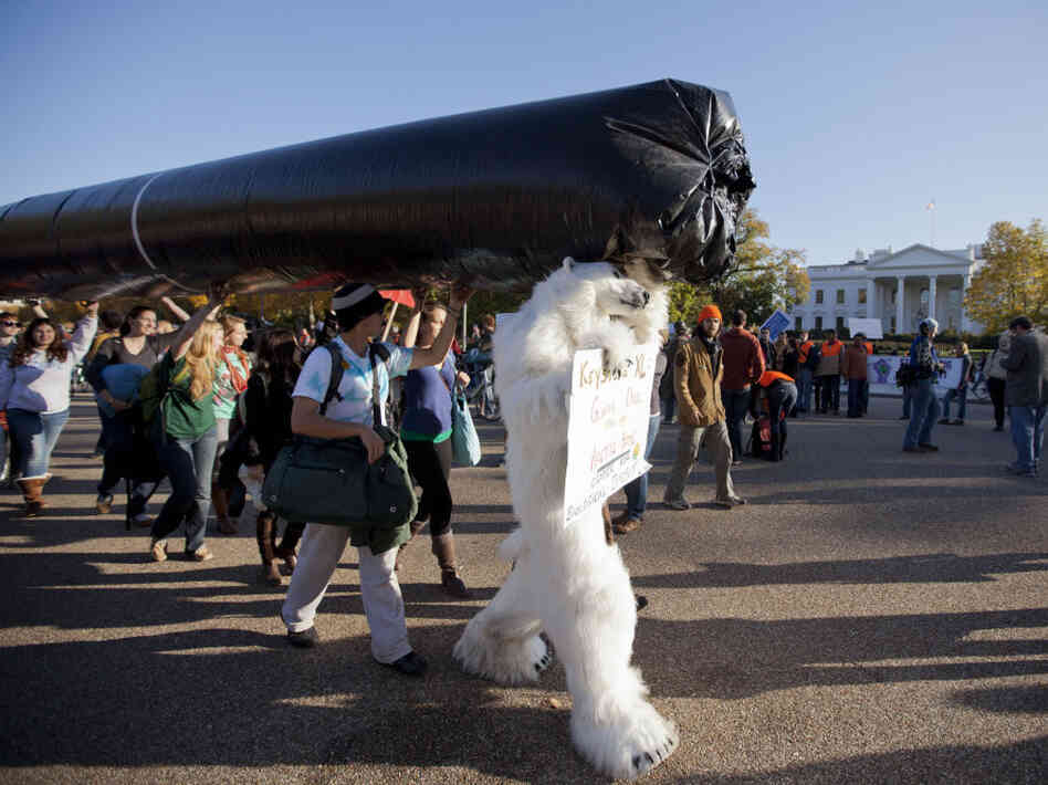 Demonstrators march with a replica of a pipeline during a protest to demand a stop to the Keystone XL tar sands oil pipeline outside the White House last November. 