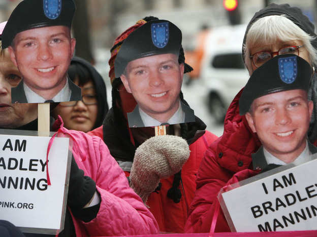CodePink activists hold signs last January in support of U.S. Army Pfc. Bradley Manning, the alleged leaker of documents to WikiLeaks. Manning will appear in court for the first time Friday.