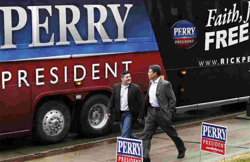 Republican presidential candidate Rick Perry walks with former Marine officer Dan Moran during a campaign stop Wednesday in Council Bluffs, Iowa. Republican presidential candidate Rick Perry walks with former Marine officer Dan Moran during a campaign stop Wednesday in Council Bluffs, Iowa.