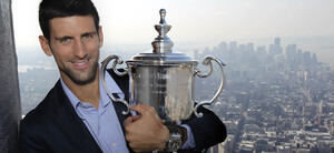 Novak Djokovic smiles with his U.S. Open trophy atop the Empire State Building in New York, Sept. 13, 2011. The Serbian defeated Rafael Nadal to win his first U.S. Open tennis championship and third Grand Slam trophy of 2011.