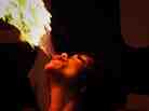 A woman breathing fire