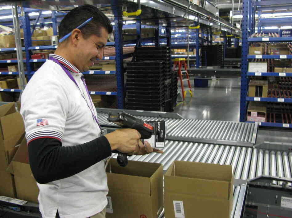 Javier Polendo, an employee at a largely automated Target.com fulfillment center in Tucson, Ariz., scans items to be shipped to online customers. Javier Polendo, an employee at a largely automated Target.com fulfillment center in Tucson, Ariz., scans items to be shipped to online customers.