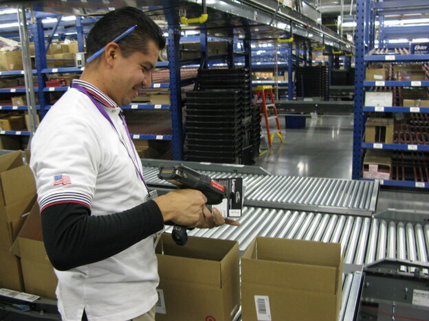 Javier Polendo, an employee at a largely automated Target.com fulfillment center in Tucson, Ariz., scans items to be shipped to online customers. Javier Polendo, an employee at a largely automated Target.com fulfillment center in Tucson, Ariz., scans items to be shipped to online customers.