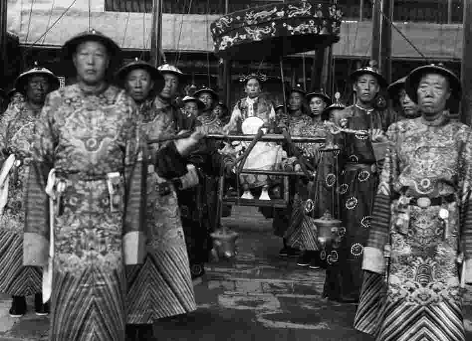 Cixi sits in a sedan chair, surrounded by eunuchs, circa 1903-04. Rumor has it that Cixi bribed the eunuchs to get better access to the emperor. Out of dozens of concubines, Cixi was the only one to bear a child.