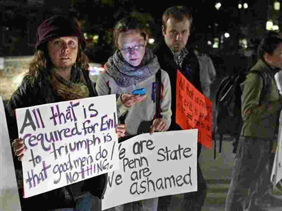 Students stand outside Penn State's Old Main building, protesting the handling of a child abuse scandal involving retired Penn State assistant football coach Jerry Sandusky. Students stand outside Penn State's Old Main building, protesting the handling of a child abuse scandal involving retired Penn State assistant football coach Jerry Sandusky.