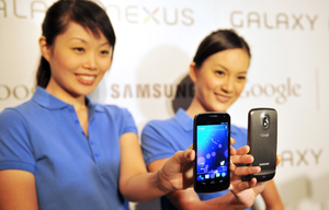 Models hold the new Samsung Galaxy Nexus Android phone during its official launch in Hong Kong in October. The new smartphone runs Google's Android Models hold the new Samsung Galaxy Nexus Android phone during its official launch in Hong Kong in October. The new smartphone runs Google's Android