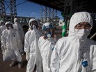Workers in protective suits and masks wait to enter the emergency operation center at the crippled Fukushima Dai-ichi nuclear power station on Nov. 12, 2011. Workers in protective suits and masks wait to enter the emergency operation center at the crippled Fukushima Dai-ichi nuclear power station on Nov. 12, 2011.