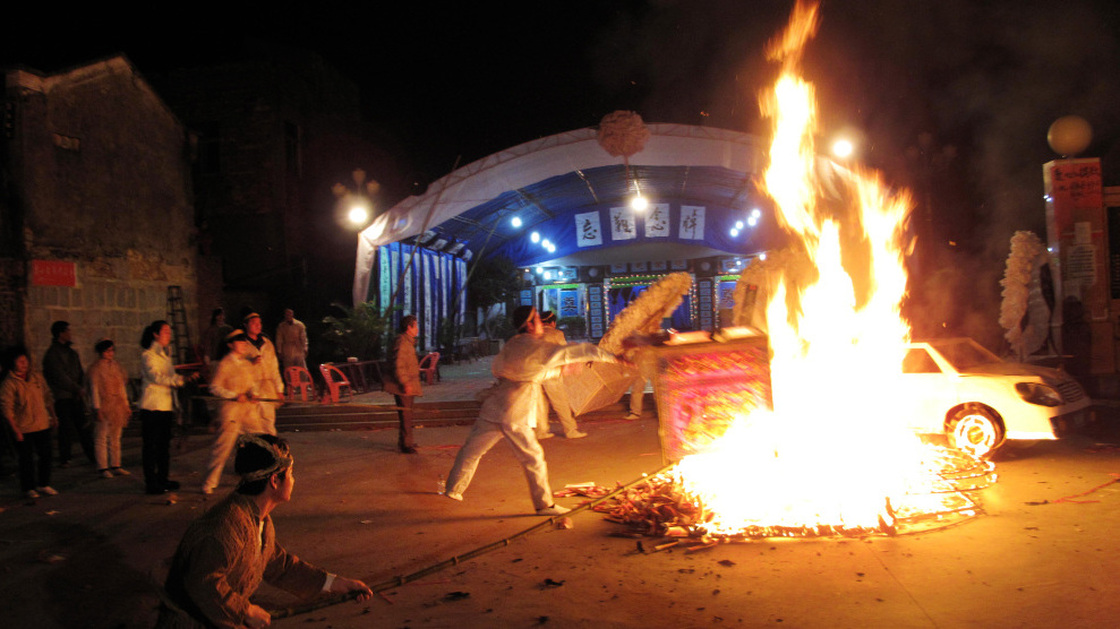 Family members burn funeral offerings for Xue Jinbo on Friday. Xue, 42, was involved in a property dispute that turned into a major confrontation with authorities in the southern Chinese village of Wukan. He died in police custody. 