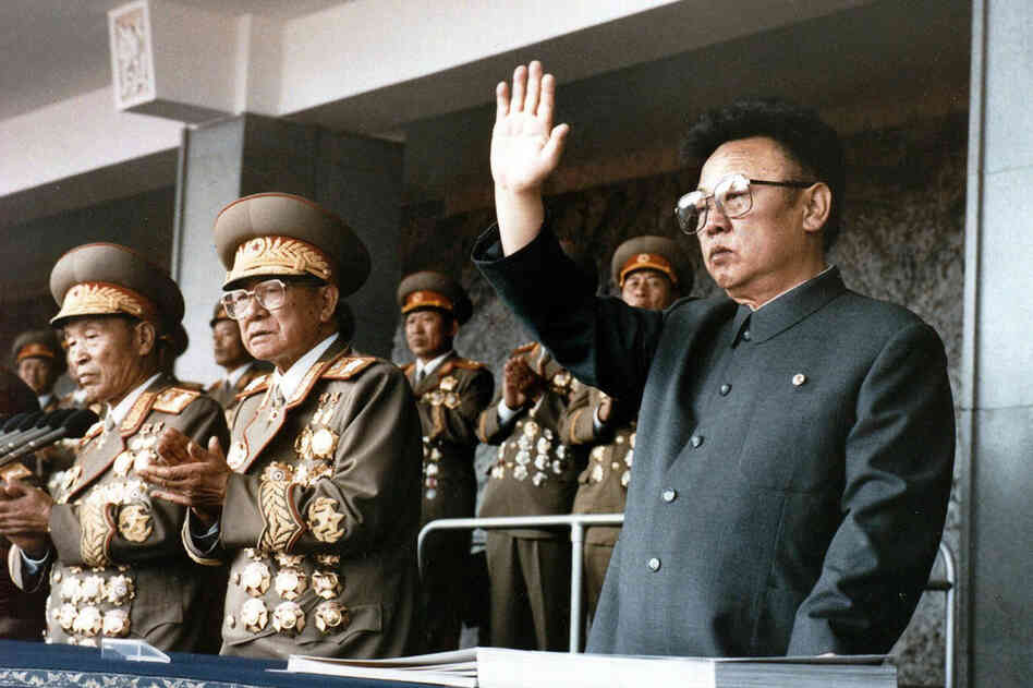 1995: Kim Jong Il (right) waves at a military parade to celebrate the 50th anniversary of the founding of the Workers' Party of Korea. 