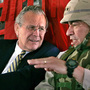 Secretary of Defense Donald Rumsfeld, left, listens to Gen. Ricardo Sanchez, Commander of the coalition forces in Iraq, on a flight from Kuwait City to Baghdad in 2004.