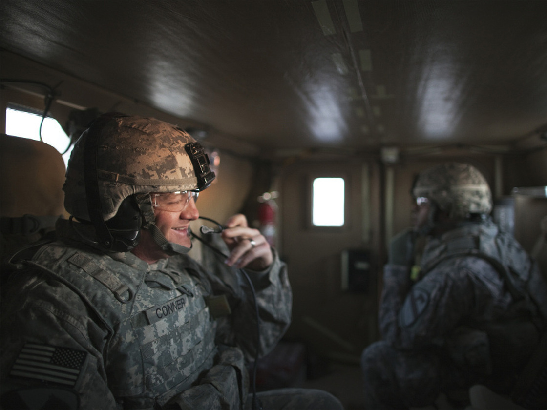 Specialist Christopher Conner smiles as his Mine Resistant Ambush Protected vehicle approaches the Kuwaiti border Sunday morning.