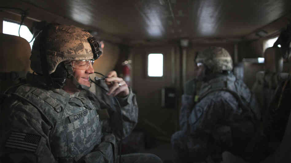 Specialist Christopher Conner smiles as his Mine Resistant Ambush Protected vehicle approaches the Kuwaiti border Sunday morning.