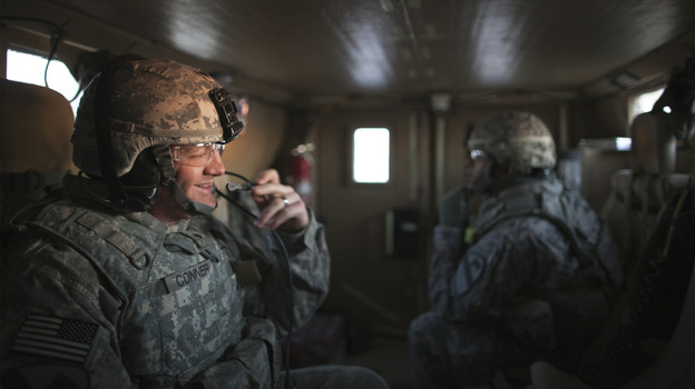 Specialist Christopher Conner smiles as his Mine Resistant Ambush Protected vehicle approaches the Kuwaiti border Sunday morning. Specialist Christopher Conner smiles as his Mine Resistant Ambush Protected vehicle approaches the Kuwaiti border Sunday morning.