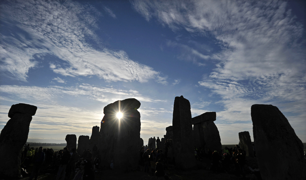 The sun rises behind Stonehenge as revellers celebrate the pagan festival of 'Summer Solstice' in 2010. 