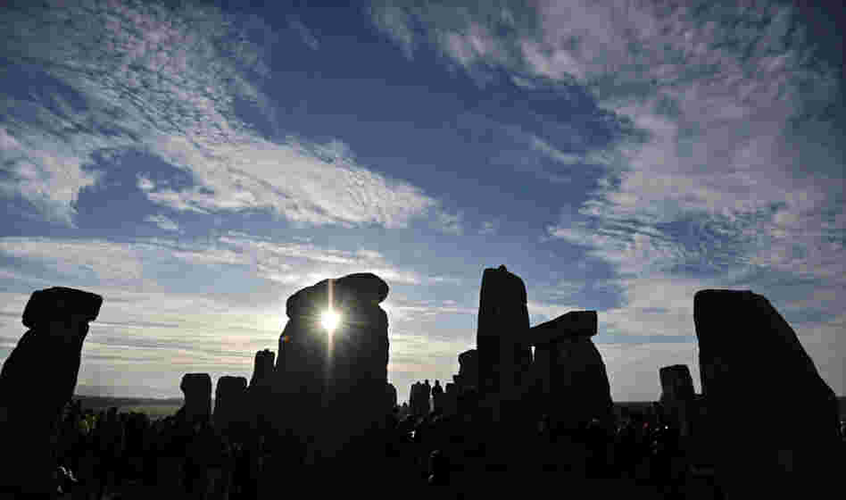 The sun rises behind Stonehenge as revellers celebrate the pagan festival of 'Summer Solstice' in 2010. 