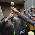 Students give carnations to riot police at Bogota's main square Plaza de Bolivar during a Nov. 10, 2011 demonstration against an education reform bill. Students give carnations to riot police at Bogota's main square Plaza de Bolivar during a Nov. 10, 2011 demonstration against an education reform bill.