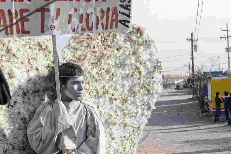 Young members of the evangelical church Psalm 100 in Ciudad Juarez dress as "messenger angels" to silently protest the Mexican city's ongoing violence. Here, 15-year-old Adan Ubacio Lopez holds a sign that translates to "Behold, I am here, Lord. I will bear your glory." 