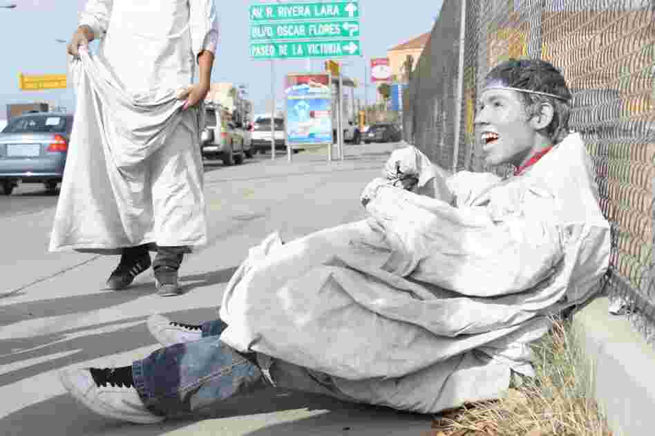 Adan sits on the ground and jokes that even angels need to rest sometimes.