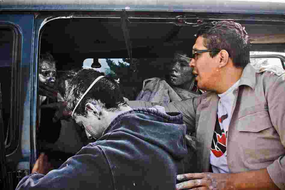 Carlos Mayorga, the youth minister of Psalm 100, helps angels into their van to ride around the city. They've nicknamed the van "The Weenie" for its length.