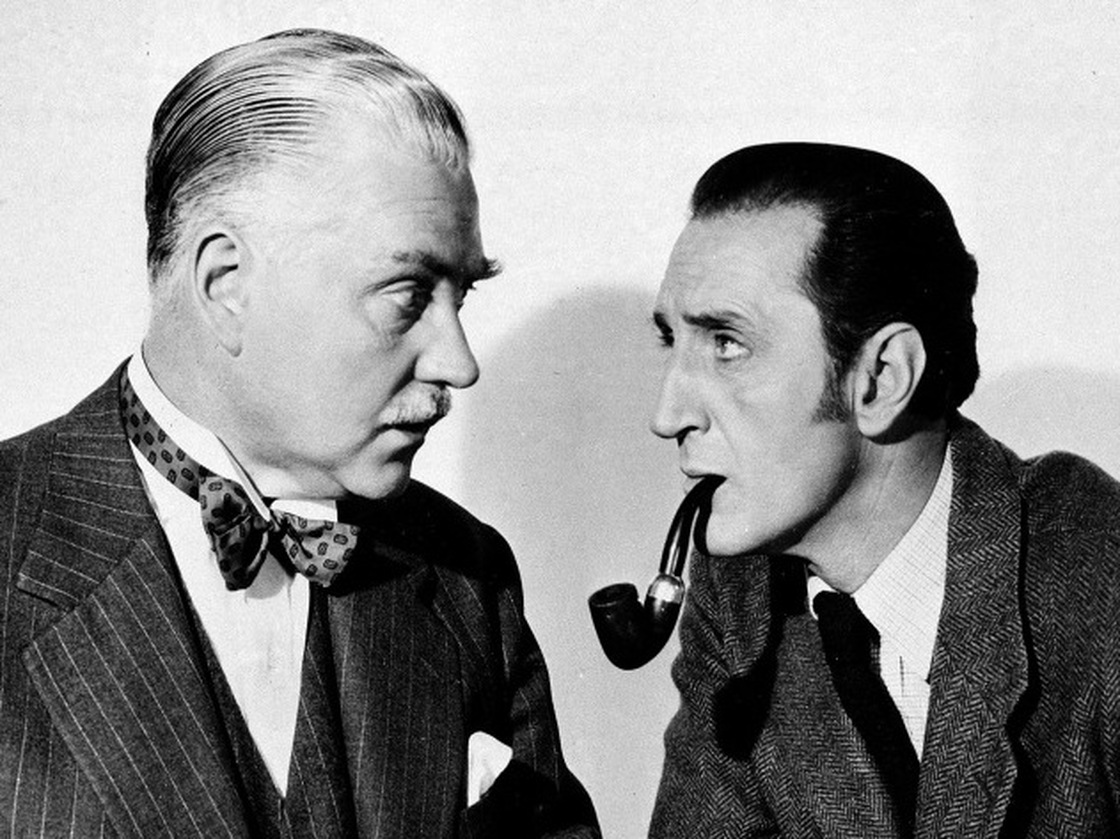 Basil Rathbone (right), as Sherlock Holmes, and Nigel Bruce, as Dr. Watson, in The Adventures of Sherlock Holmes, 1945.