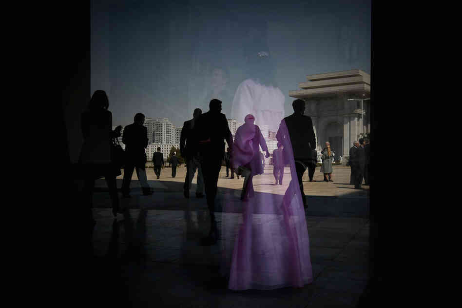 In the background of a window reflection is the Arch of Triumph in Pyongyang, North Korea. Built in the 1970s, it's taller than its Paris equivalent.