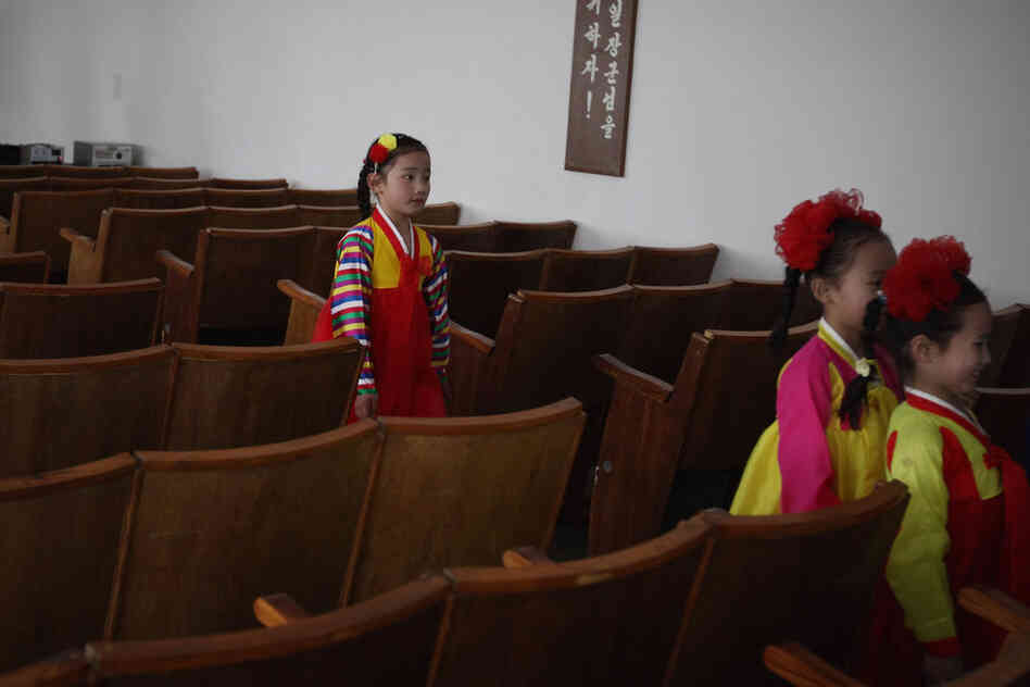 North Korean children leave the classroom after performing in a primary school.