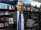 E-books surged in popularity in 2011. Here, Jean-Louis Raynard, chairman of the board of Virgin Megastore France, poses with the Cybook Odyssey tablet (left) a French e-reader from Bookeen, and the Kindle tablet (right), developed by Amazon.
