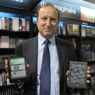 E-books surged in popularity in 2011. Here, Jean-Louis Raynard, chairman of the board of Virgin Megastore France, poses with the Cybook Odyssey tablet (left) a French e-reader from Bookeen, and the Kindle tablet (right), developed by Amazon.