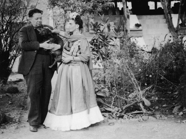 Diego Rivera holds a pet dog alongside his wife, artist Frida Kahlo, in Mexico City, Mexico.