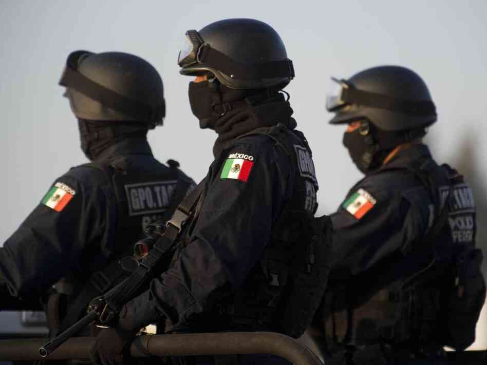 Federal policemen escort the armored car carrying a member of Los Zetas drug cartel in June. The security forces have been accused of abuses in the fight against the drug cartels.
