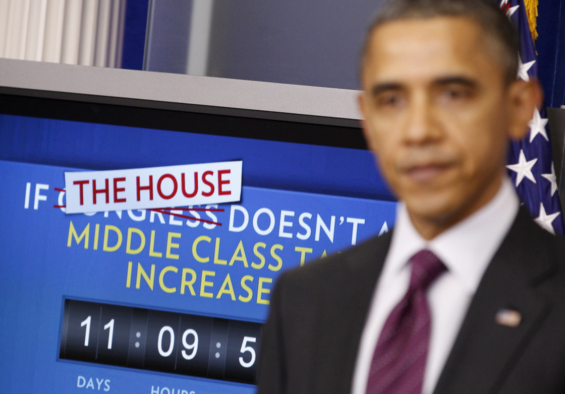 President Obama speaks in the White House's Brady Briefing Room on Tuesday. Behind the president, a ticking clock counts down the time until taxes will go up if Congress can't reach an extension deal on payroll tax cuts.