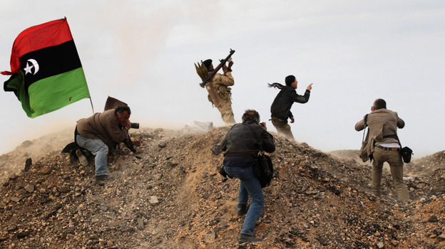 Photojournalists, including New York Times staff photographer Tyler Hicks, photograph Libyan rebels on March 10 in Ras Lanuf, Libya. Hicks and three other Times journalists — Stephen Farrell, Lynsey Addario and Anthony Shadid — were released March 21 after being held captive by Libyan forces. 