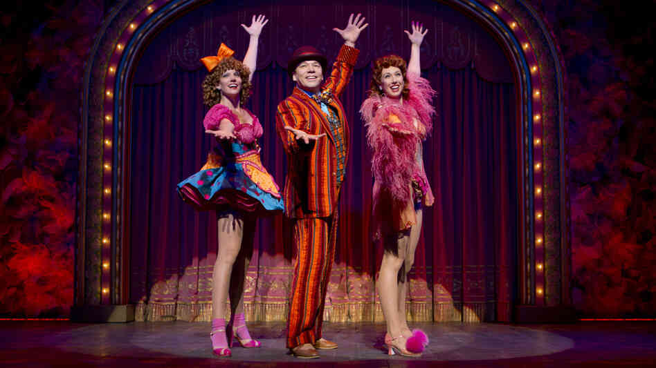 Danny Burstein, as Buddy Plummer, performs "Buddy's Blues," the high-energy song-and-dance number at the end of Follies, with Jenifer Foote (left) and Kiira Schmidt. Danny Burstein, as Buddy Plummer, performs "Buddy's Blues," the high-energy song-and-dance number at the end of Follies, with Jenifer Foote (left) and Kiira Schmidt.