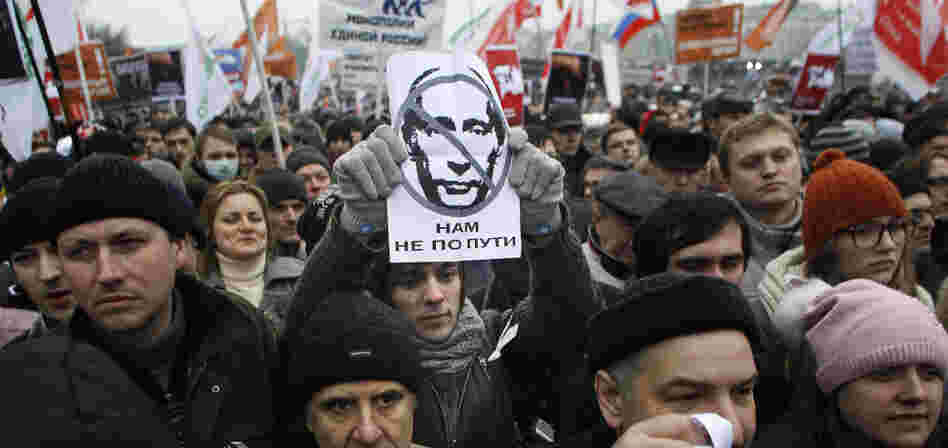 A protester holds a portrait of Putin with the words read as " we are going different ways" during a mass rally to protest against alleged vote rigging in Russia's parliamentary elections in Moscow, Russia, Saturday, Dec. 10, 2011. A protester holds a portrait of Putin with the words read as " we are going different ways" during a mass rally to protest against alleged vote rigging in Russia's parliamentary elections in Moscow, Russia, Saturday, Dec. 10, 2011.
