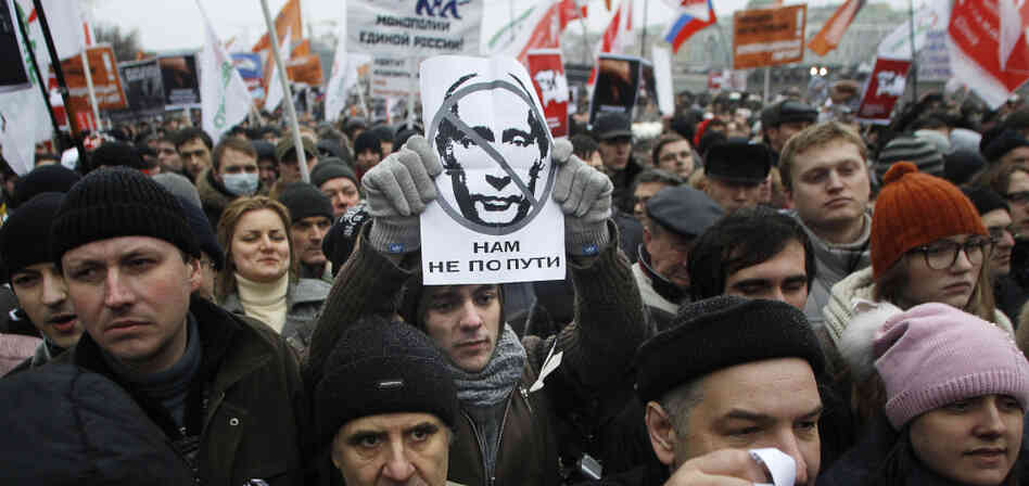 A protester holds a portrait of Putin with the words read as " we are going different ways" during a mass rally to protest against alleged vote rigging in Russia's parliamentary elections in Moscow, Russia, Saturday, Dec. 10, 2011. A protester holds a portrait of Putin with the words read as " we are going different ways" during a mass rally to protest against alleged vote rigging in Russia's parliamentary elections in Moscow, Russia, Saturday, Dec. 10, 2011.