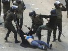 Egyptian army soldiers arrest a female protester during clashes at Tahrir Square in Cairo on Dec. 17. Egyptian army soldiers arrest a female protester during clashes at Tahrir Square in Cairo on Dec. 17.
