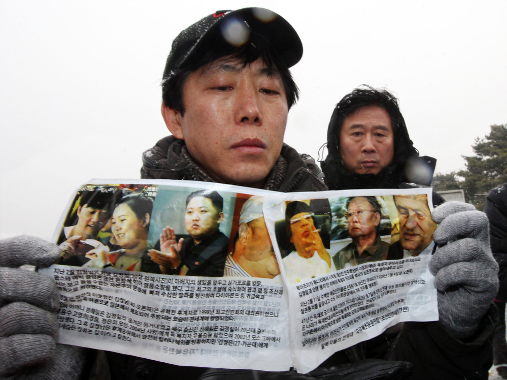 Park Sang-nak, a North Korean defector, displays anti-North Korea leaflets before sending them by balloon into North Korea, at Imjinggak peace park in South Korea near the Demilitarized Zone dividing the two Koreas on Wednesday. Defectors from the North are hoping the death of North Korean leader Kim Jong Il may provide an opportunity for political change.
