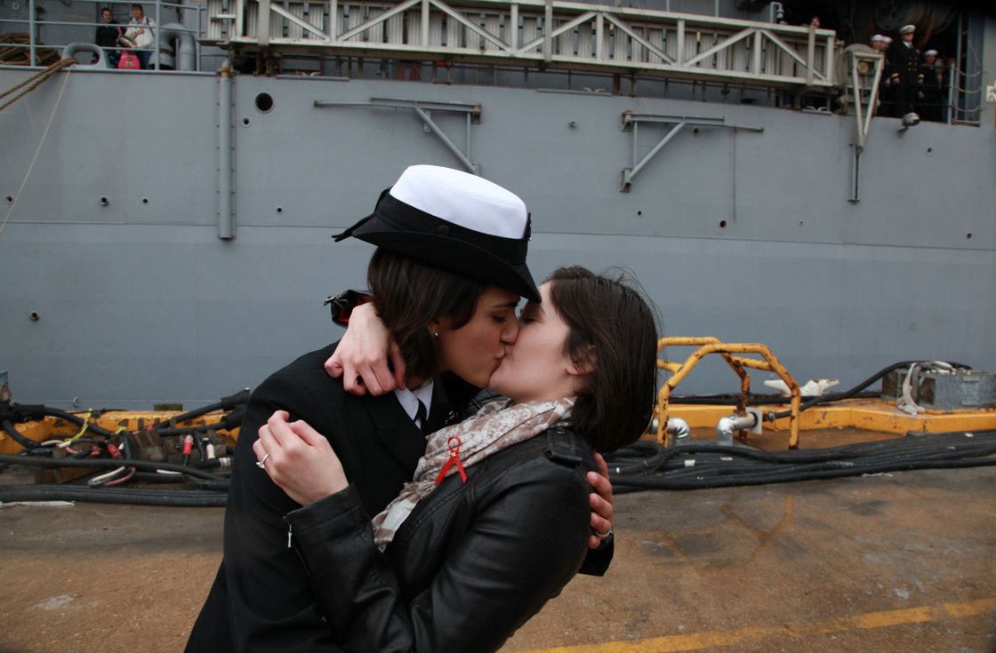 Petty Officer 2nd Class Marissa Gaeta, left, kisses her girlfriend of two years, Petty Officer 3rd Class Citlalic Snell at Joint Expeditionary Base Little Creek in Virginia Beach, Va. Gaeta's ship returned from 80 days at sea on Wednesday.