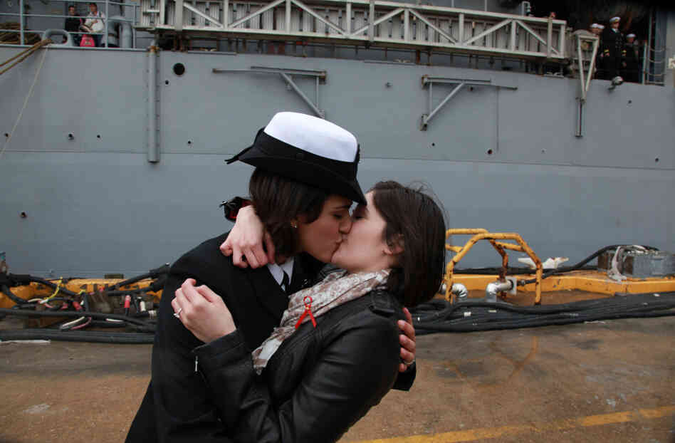 Petty Officer 2nd Class Marissa Gaeta, left, kisses her girlfriend of two years, Petty Officer 3rd Class Citlalic Snell at Joint Expeditionary Base Little Creek in Virginia Beach, Va. Gaeta's ship returned from 80 days at sea on Wednesday.