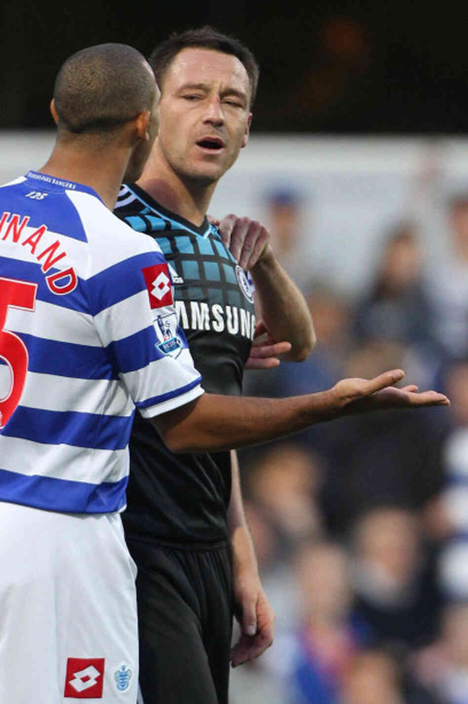 John Terry, right, and opponent Anton Ferdinand during the English Premier League on Oct. 23 in which it's alleged that Terry hurled a racial slur at Ferdinand. Terry denies doing that. He's going to face criminal charges. John Terry, right, and opponent Anton Ferdinand during the English Premier League on Oct. 23 in which it's alleged that Terry hurled a racial slur at Ferdinand. Terry denies doing that. He's going to face criminal charges.