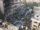Iraqi security forces gathered at the site of a car bomb blast, one of more than a dozen seemingly coordinated explosions across Baghdad on Thursday. Iraqi security forces gathered at the site of a car bomb blast, one of more than a dozen seemingly coordinated explosions across Baghdad on Thursday.