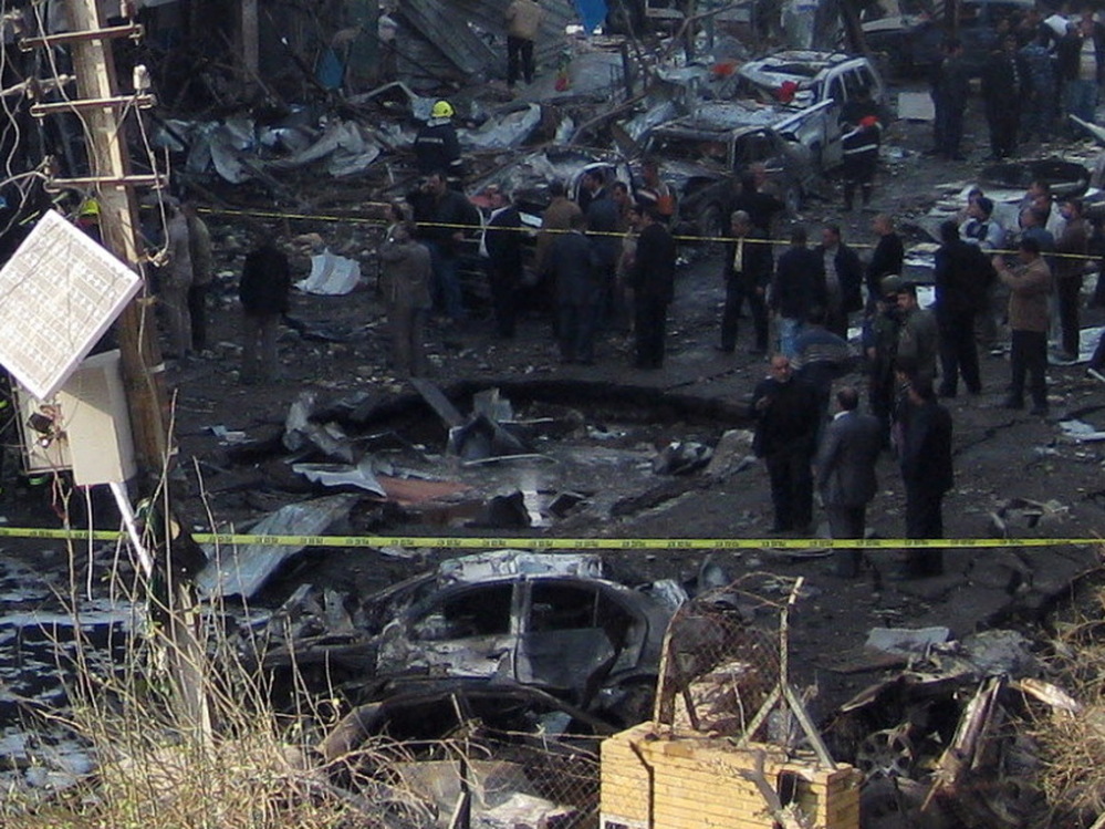 Iraqi security forces inspect a crater caused by a car bomb attack in the neighborhood of Karrada in Baghdad earlier today (Dec. 22, 2011). It was one in a wave of such bombings in the Iraqi capital today. 