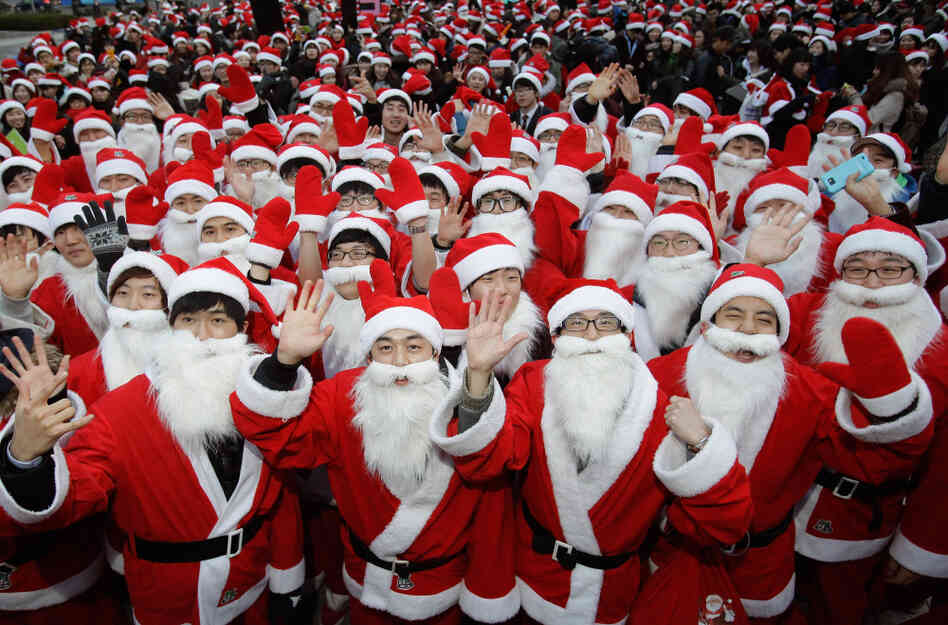 South Koreans wear Santa Claus outfits and hold gifts to promote Christmas at a charity event in Seoul on Friday. South Koreans wear Santa Claus outfits and hold gifts to promote Christmas at a charity event in Seoul on Friday.
