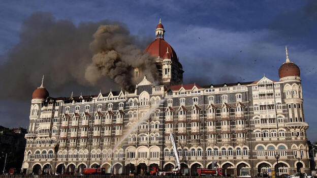 Indian firefighters attempt to put out a fire as smoke billows out of the historic Taj Mahal Hotel in Mumbai, which was stormed by armed gunmen in November 2008.