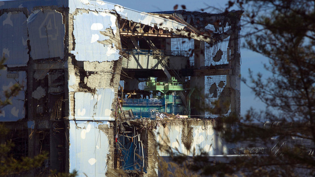 The crippled Fukushima Dai-ichi nuclear power station is seen through a bus window on Nov. 12. The four reactors that failed were stabilized this month.