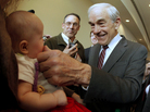 Rep. Ron Paul, R-Texas, greets 3-month-old Heidi Lange during a campaign stop in Dubuque, Iowa, on Thursday. Rep. Ron Paul, R-Texas, greets 3-month-old Heidi Lange during a campaign stop in Dubuque, Iowa, on Thursday.