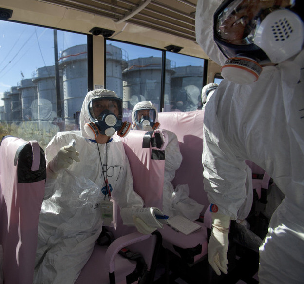 Tokyo Electric Power Co. officials and Japanese journalists look at the crippled Fukushima Dai-ichi plant in November. International media swarmed to cover the problems at the plant, but coverage died down before interest did.